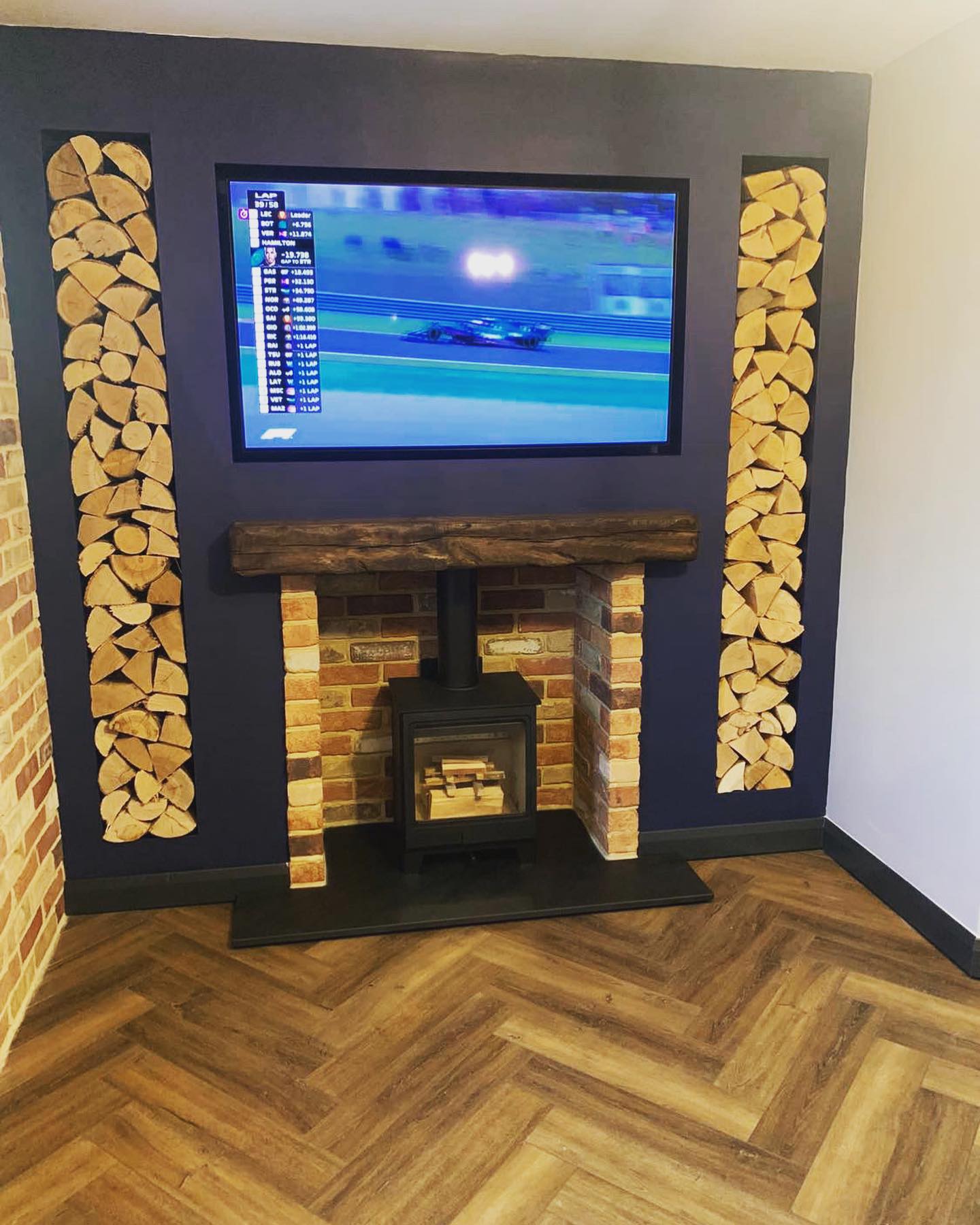 First-Floor Stove Media Wall with Built-In Log Storage