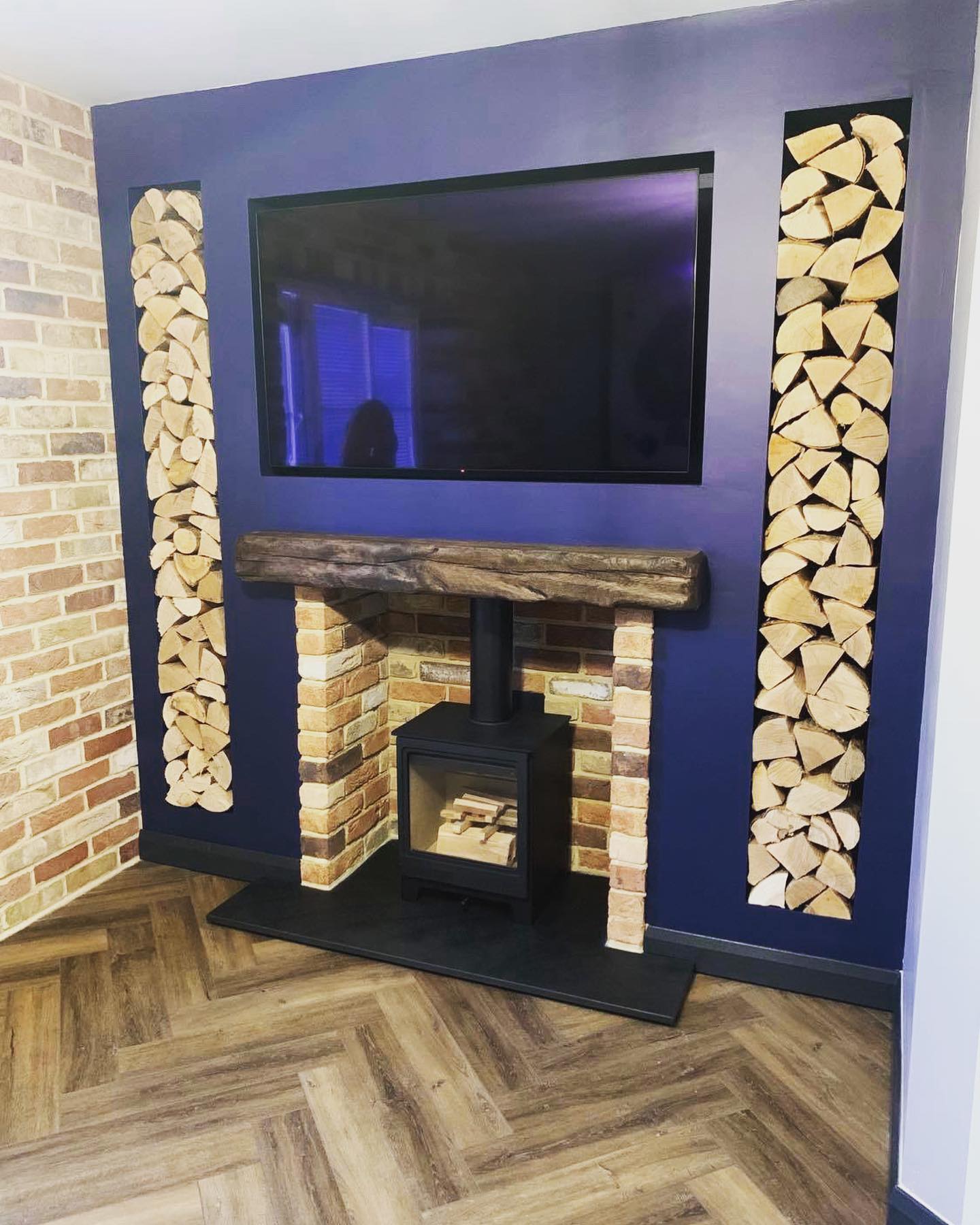 First-Floor Stove Media Wall with Built-In Log Storage