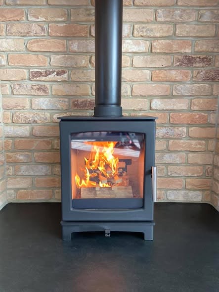 Summerhouse Stove Installation with Reclaimed Brick Heat Shield