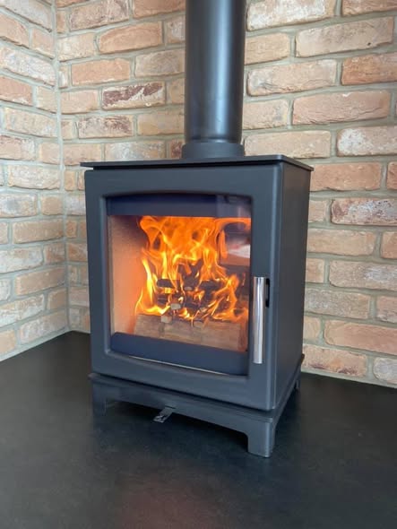 Summerhouse Stove Installation with Reclaimed Brick Heat Shield