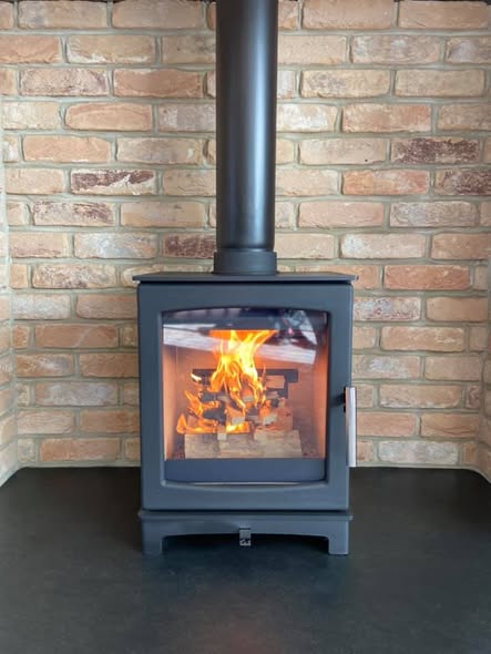 Summerhouse Stove Installation with Reclaimed Brick Heat Shield