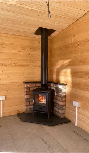 Summerhouse Stove Installation with Reclaimed Brick Heat Shield